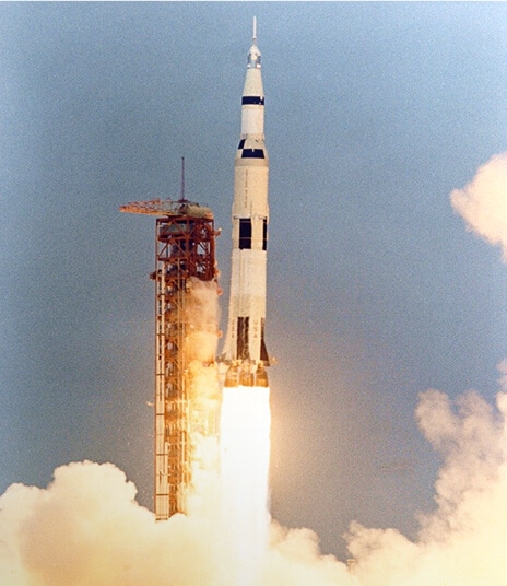 The Apollo 13 Saturn V yaws away from the launch tower during liftoff